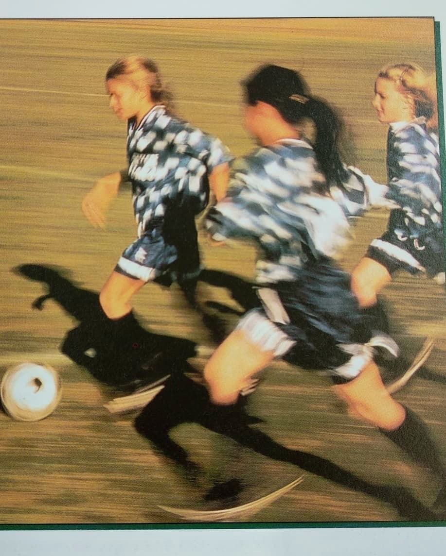Young athletes sprinting downfield